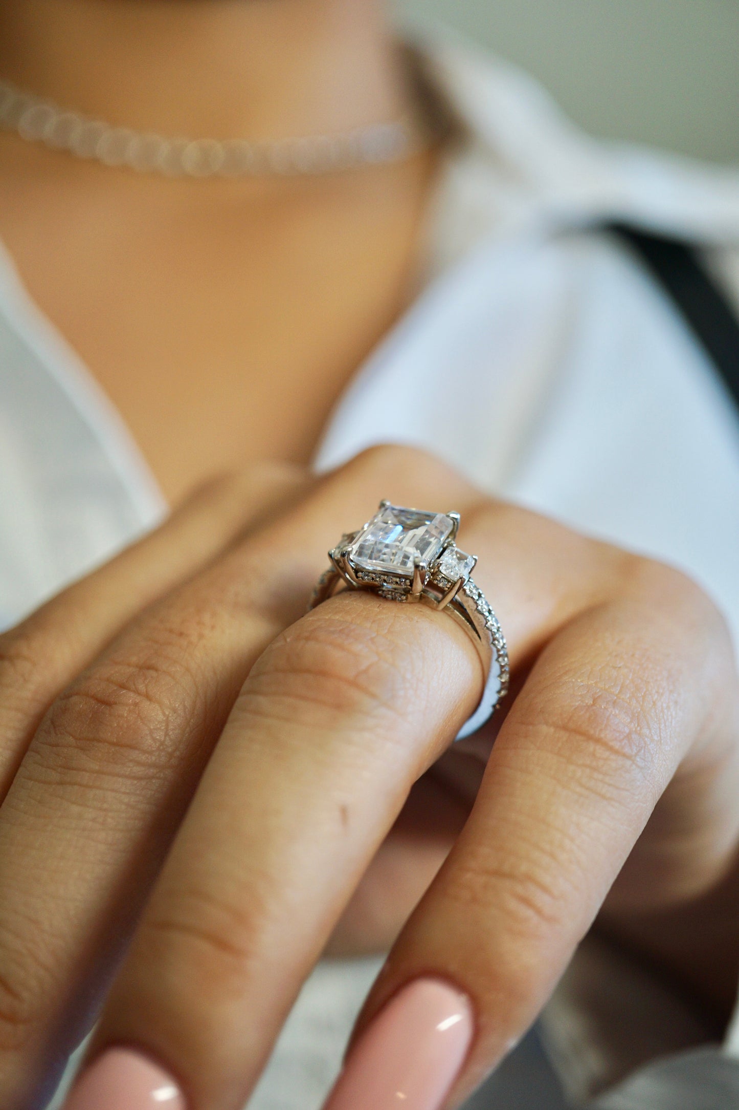 Emerald cut moissanite engagement ring with three-stone gold setting - elizabeth + Bern