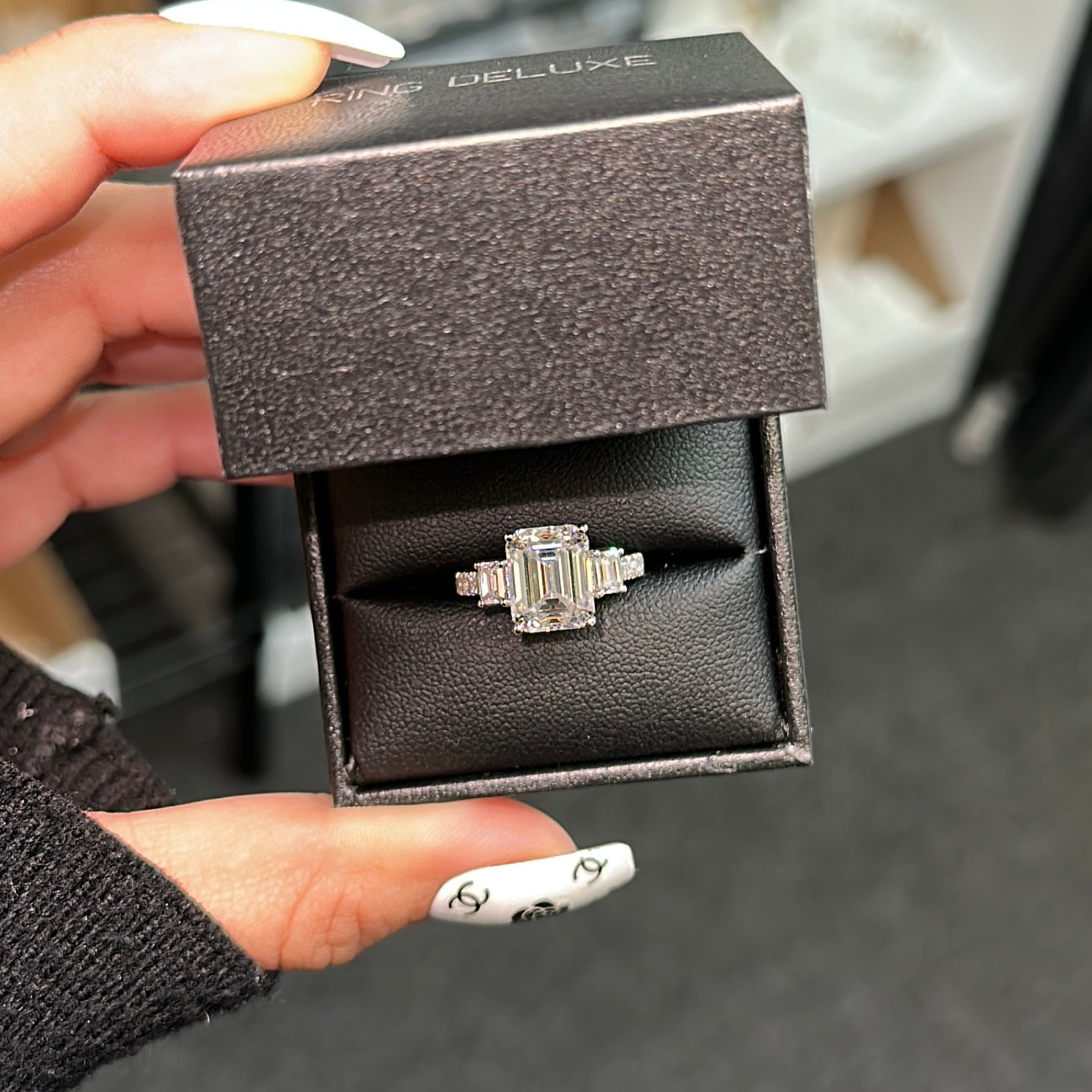 Emerald cut moissanite engagement ring with three-stone gold setting - elizabeth + Bern