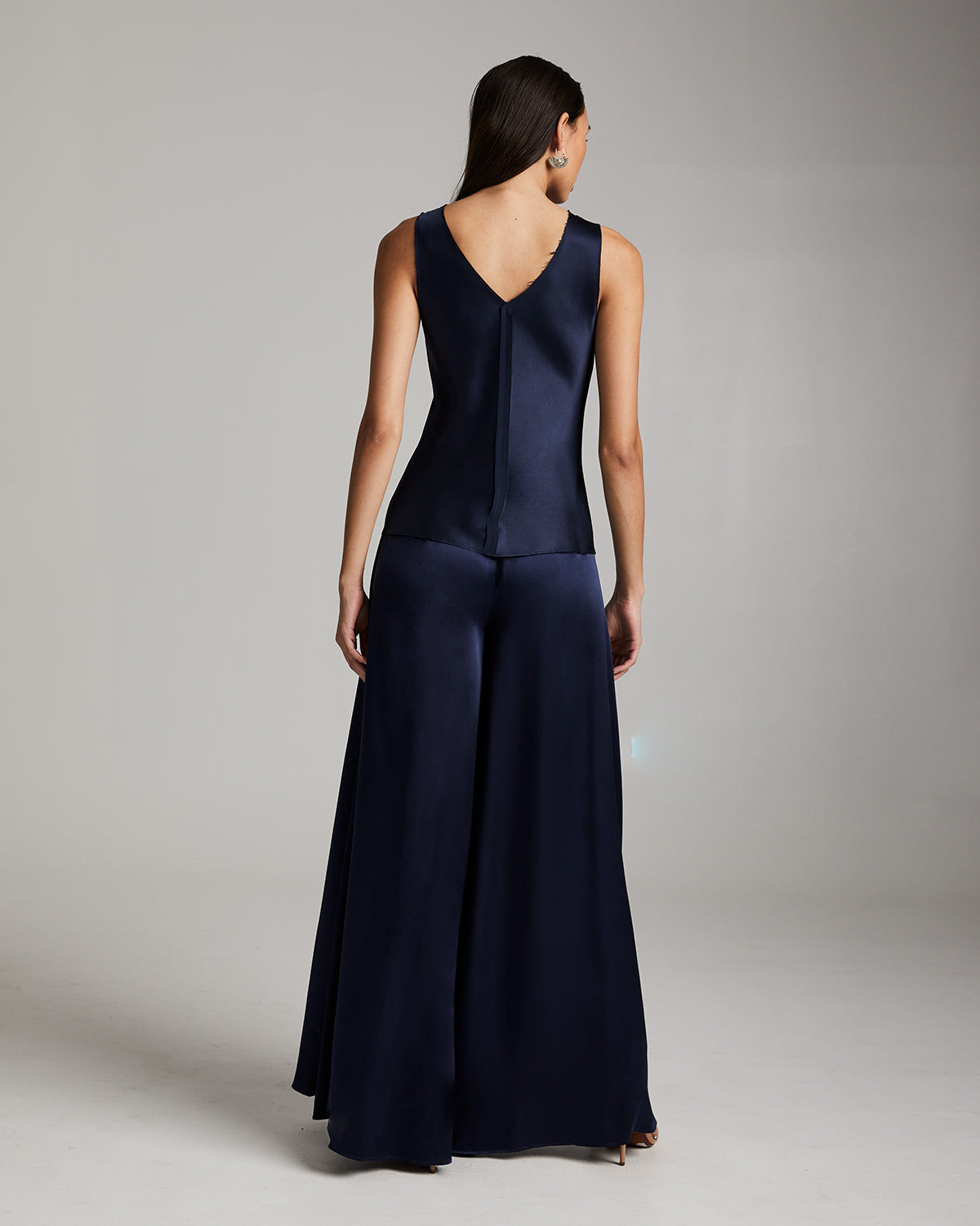 Navy blue evening gown on a model against a neutral background