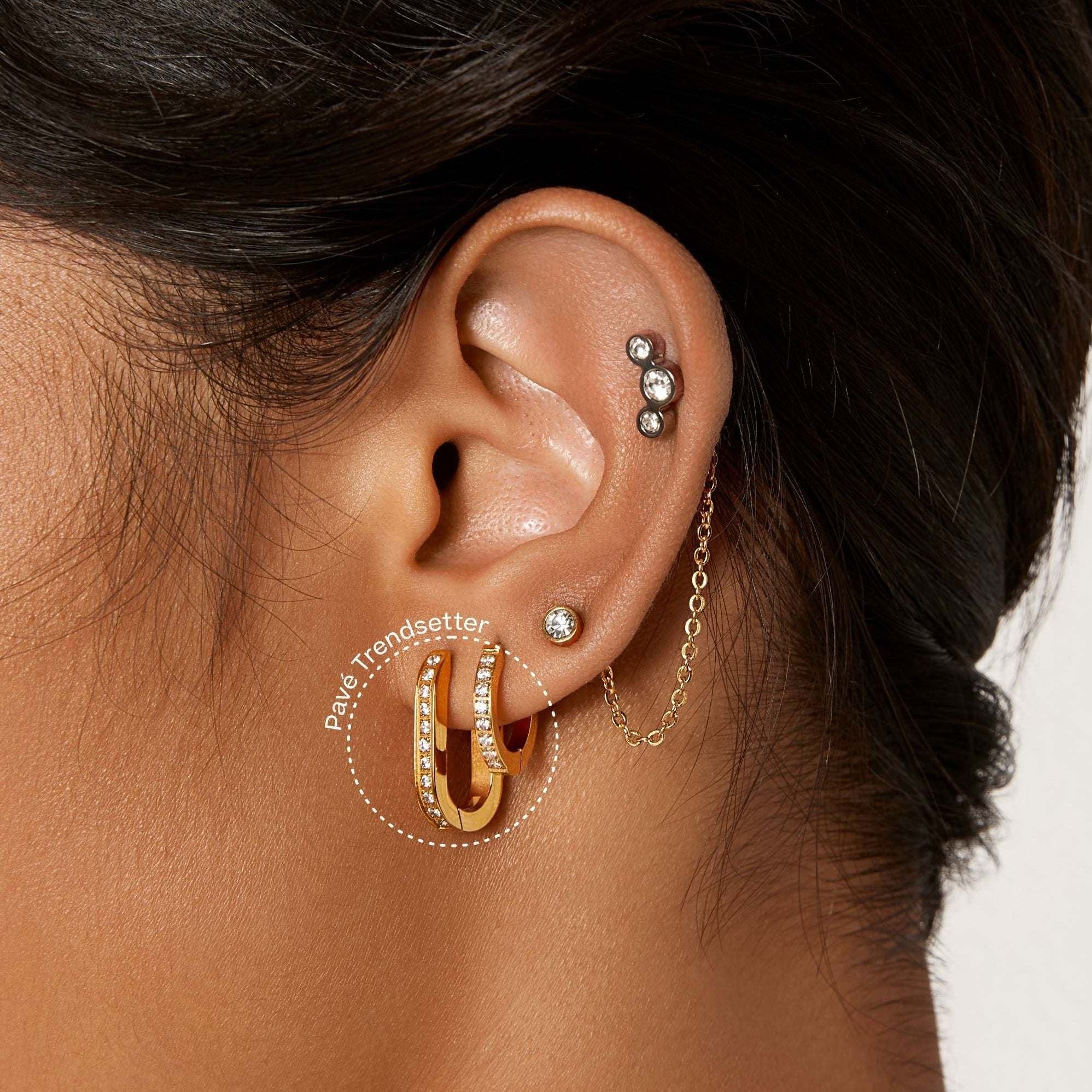 A pair of gold-plated titanium hoop earrings from the Tini Lux hypoallergenic jewelry collection at Elizabeth and Bern.