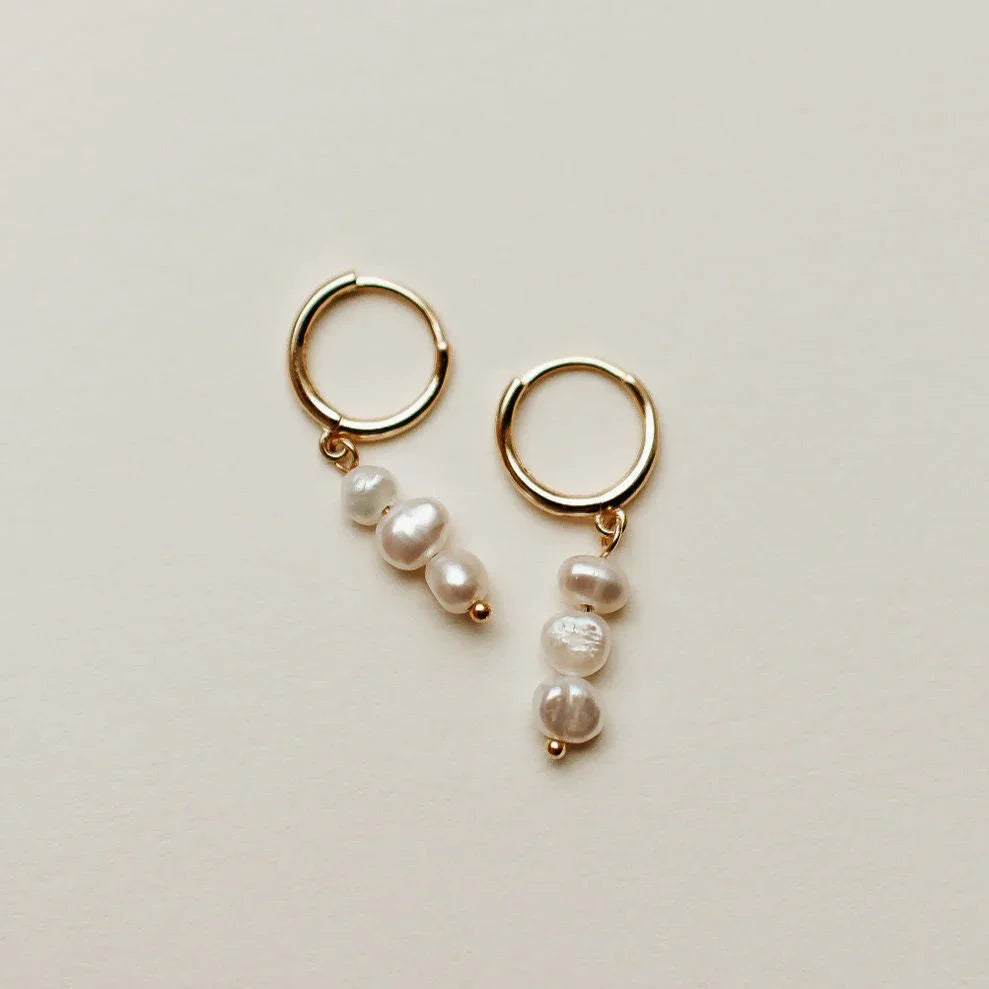 Gold hoop earrings with pearl drops at Elizabeth and Bern 
