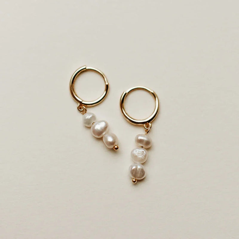 Gold hoop earrings with pearl drops at Elizabeth and Bern 