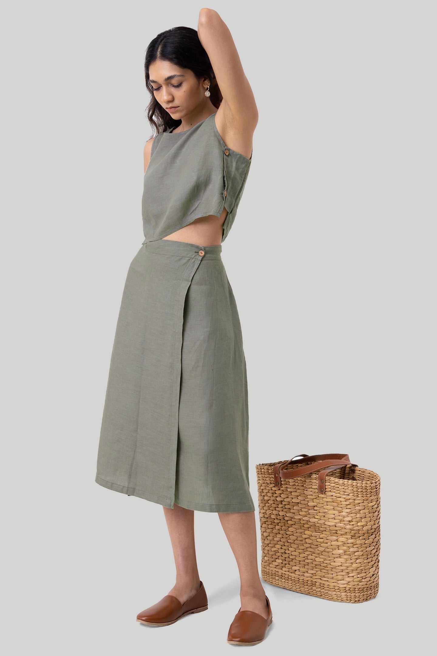 Woman wearing a green outfit with a plain background